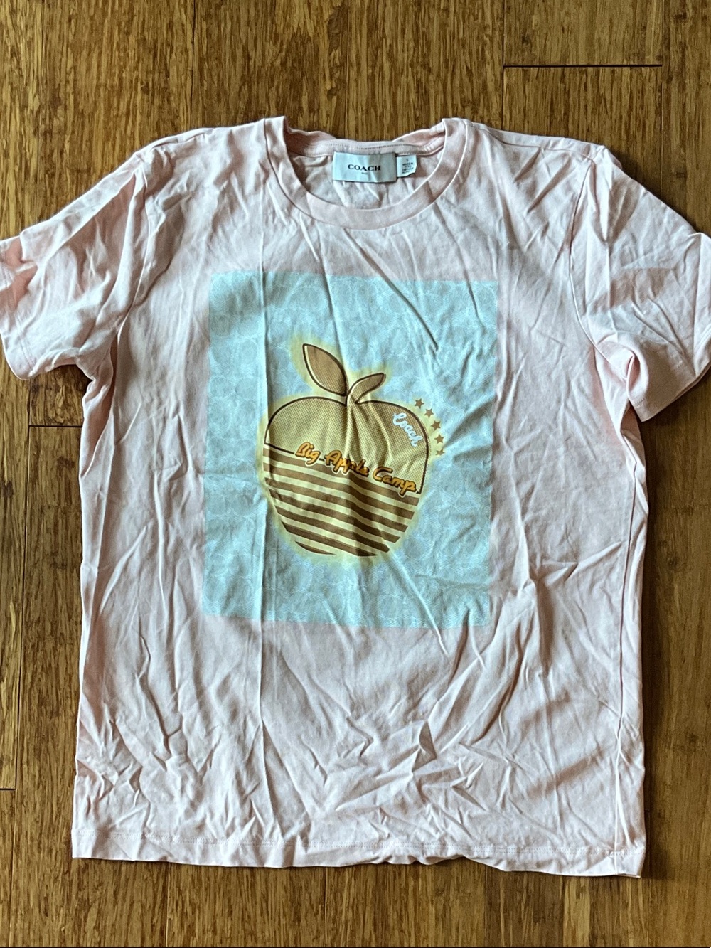 Coach Pink Tee with Gold Apple Graphic